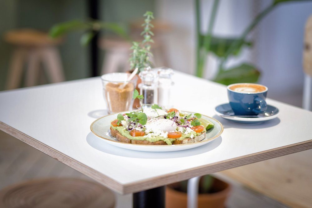 Poached eggs on avocado toast with goat cheese and cherry tomatoes, yum!